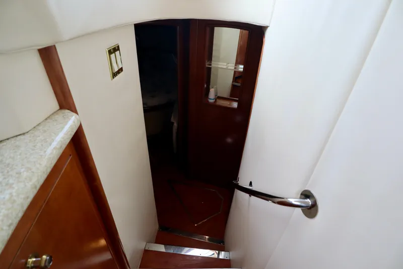 Regina Rae Yacht Photos Pics Stairway inside 1999 Carver 450 Voyager Pilothouse yacht, leading to cabin area.