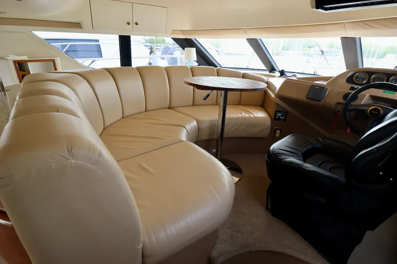 Regina Rae Yacht Photos Pics Luxurious interior of 1999 Carver 450 Voyager Pilothouse with plush seating and helm.
