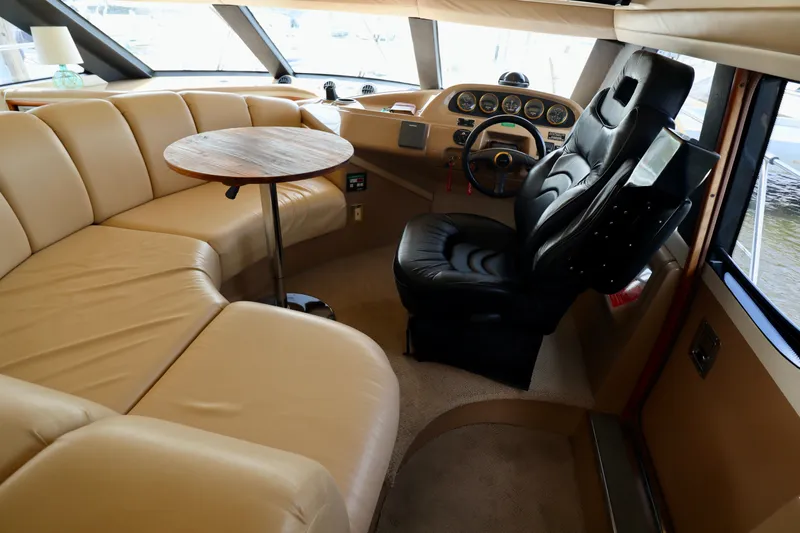 Regina Rae Yacht Photos Pics Luxurious interior of 1999 Carver 450 Voyager Pilothouse with leather seating and helm.