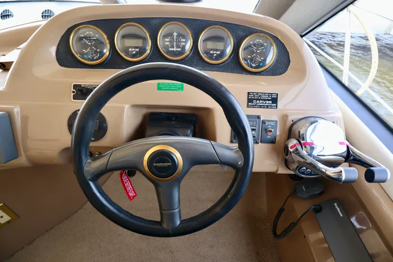 Regina Rae Yacht Photos Pics 1999 Carver 450 Voyager Pilothouse dashboard with steering wheel and control panel.