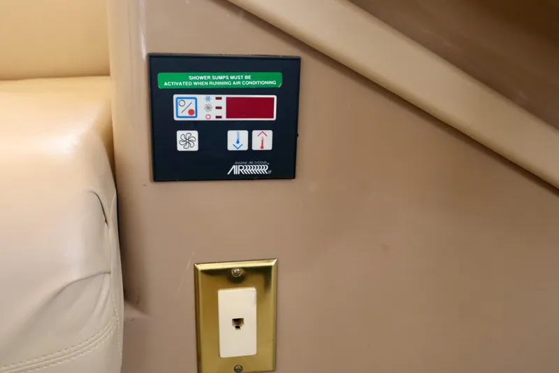 Regina Rae Yacht Photos Pics Control panel on 1999 Carver 450 Voyager Pilothouse, featuring air conditioning settings.