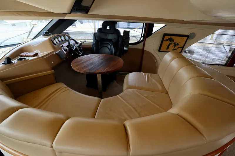 Regina Rae Yacht Photos Pics Luxurious interior of 1999 Carver 450 Voyager Pilothouse with leather seating and wooden table.