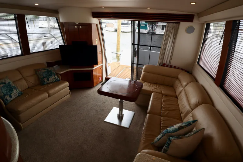 Regina Rae Yacht Photos Pics Luxurious interior of 1999 Carver 450 Voyager Pilothouse with leather seating and large windows.