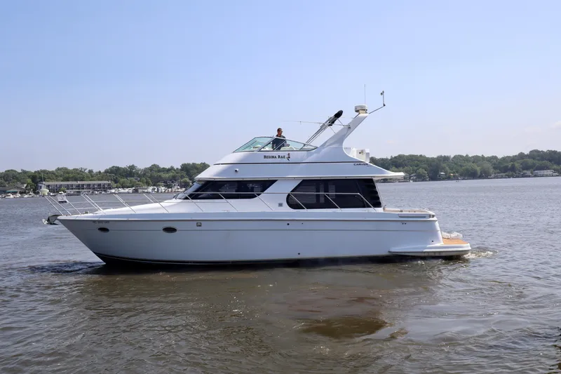 Regina Rae Yacht Photos Pics 1999 Carver 450 Voyager Pilothouse yacht cruising on a calm lake.