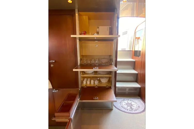  Yacht Photos Pics Interior of 2008 Riva RivaRama 44 yacht with open wooden cabinets and stairs.