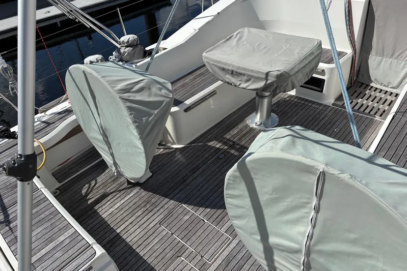  Yacht Photos Pics Covered deck area of a 2014 Bavaria Vision 46 sailboat, featuring protective covers.