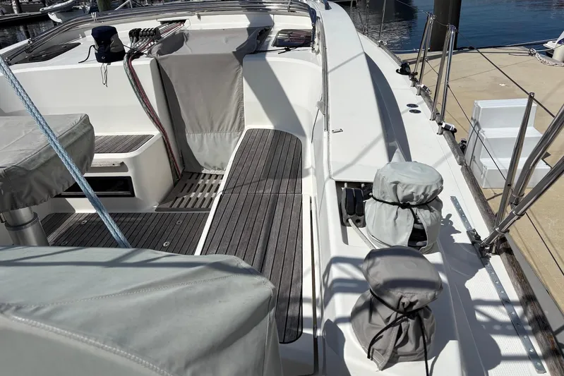  Yacht Photos Pics 2014 Bavaria Vision 46 yacht deck with covered equipment and wooden flooring.