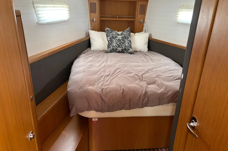  Yacht Photos Pics Cozy cabin interior of 2014 Bavaria Vision 46 yacht with comfortable bedding.