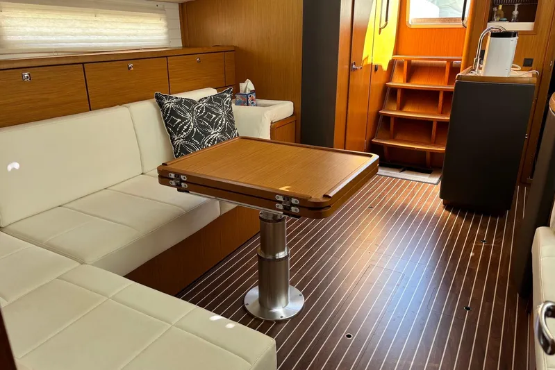  Yacht Photos Pics Interior of 2014 Bavaria Vision 46 yacht with elegant wood and white seating.
