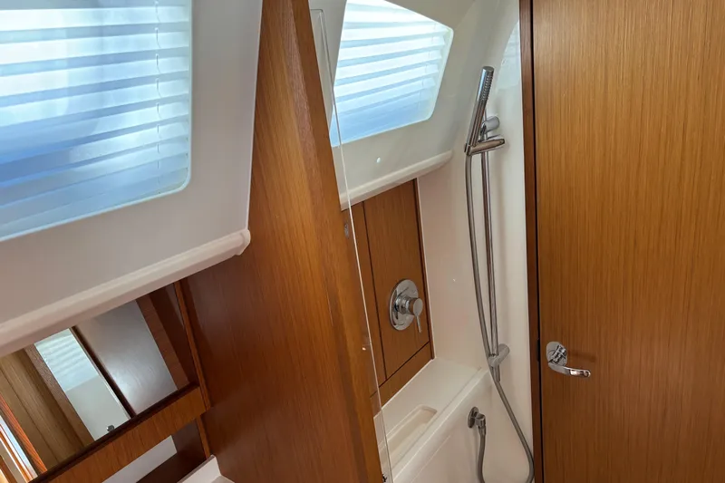  Yacht Photos Pics Interior of 2014 Bavaria Vision 46 yacht bathroom with wooden finish and modern shower.