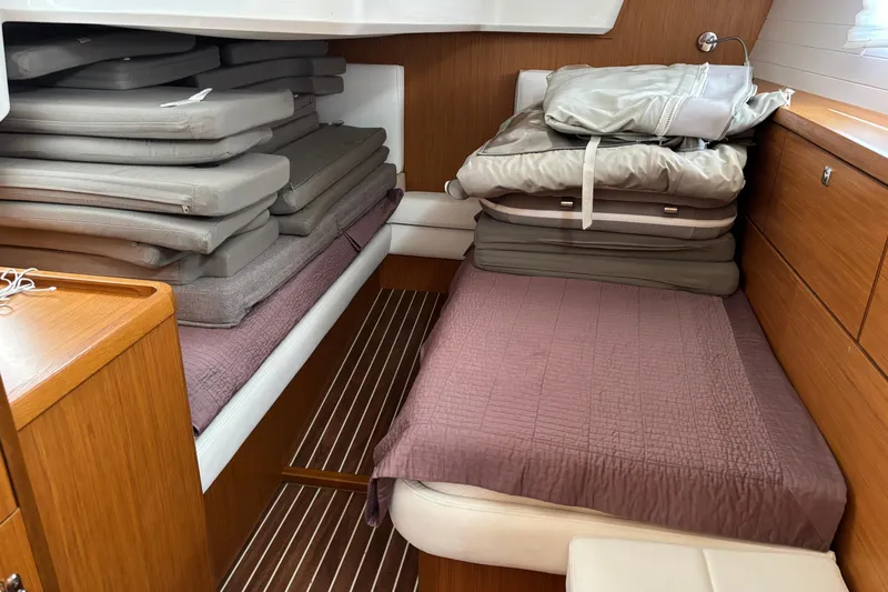  Yacht Photos Pics Interior cabin of 2014 Bavaria Vision 46 yacht with stacked cushions and bedding.