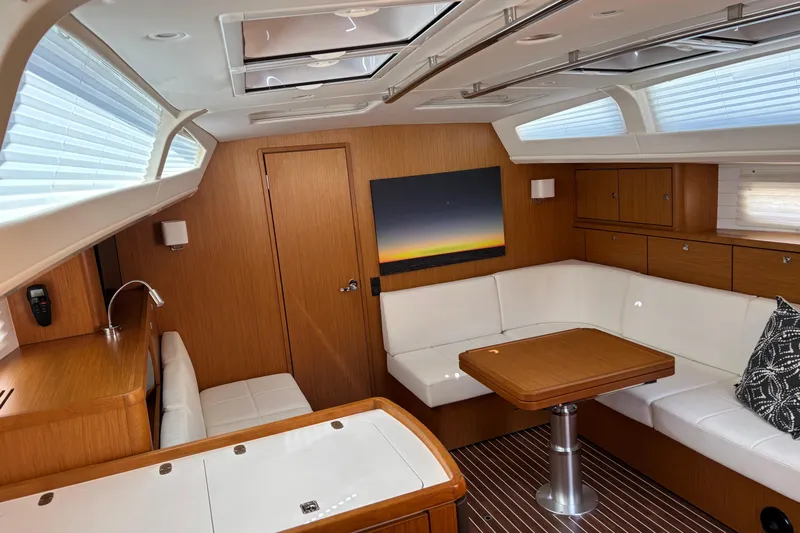  Yacht Photos Pics Luxurious interior of 2014 Bavaria Vision 46 yacht with elegant wood finish and white seating.