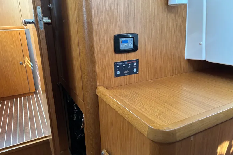  Yacht Photos Pics Interior of 2014 Bavaria Vision 46 yacht with control panel and wooden finish.