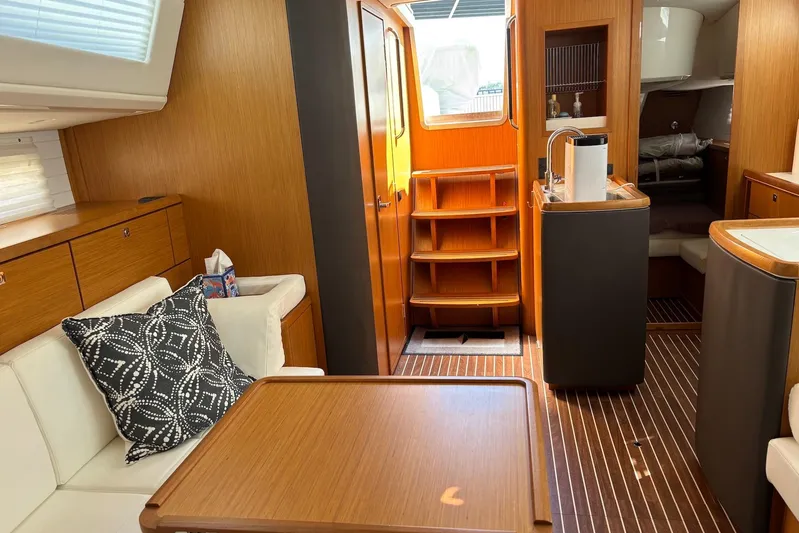  Yacht Photos Pics Interior of 2014 Bavaria Vision 46 yacht with modern wood finish and cozy seating.