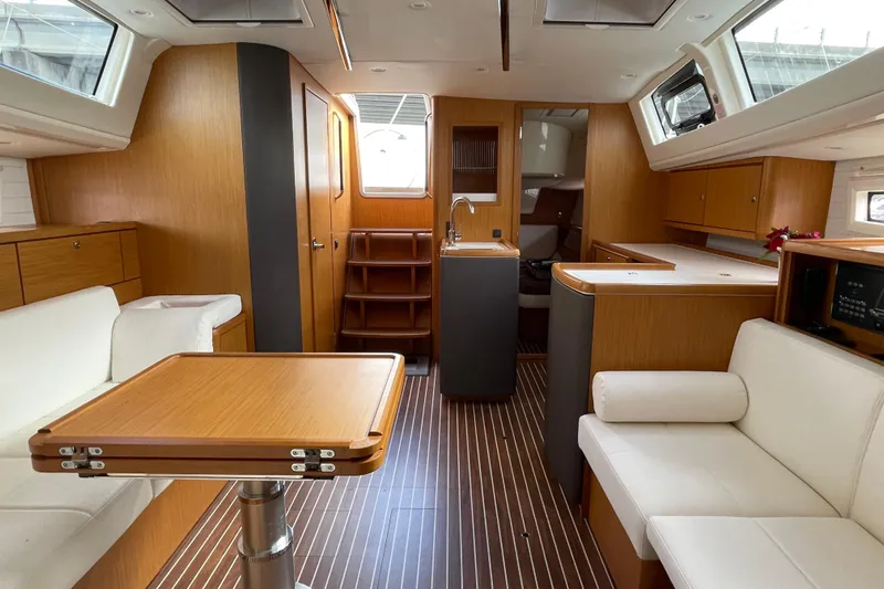  Yacht Photos Pics Luxurious interior of 2014 Bavaria Vision 46 yacht with modern wood finish and seating.