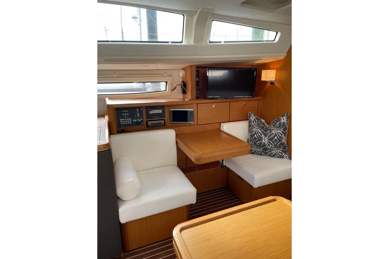  Yacht Photos Pics Interior of 2014 Bavaria Vision 46 yacht with seating, table, and navigation equipment.