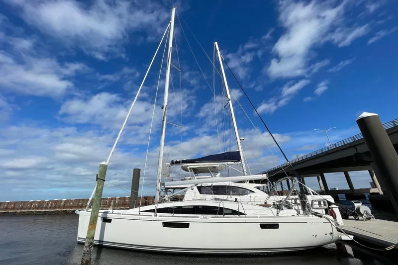  Yacht Photos Pics 2014 Bavaria Vision 46 sailboat docked under a blue sky near a bridge.
