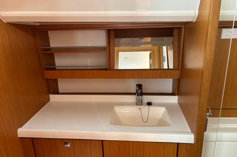  Yacht Photos Pics Interior of 2014 Bavaria Vision 46 yacht featuring a wooden vanity with sink and mirror.
