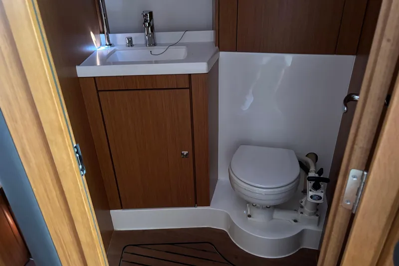  Yacht Photos Pics Compact bathroom in 2014 Bavaria Vision 46 yacht with sink and toilet.