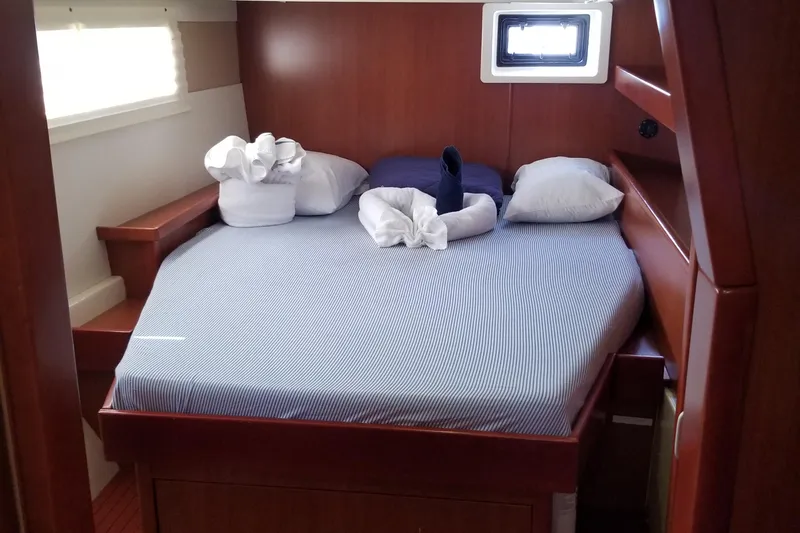 Zumbrota Yacht Photos Pics Cozy cabin bedroom in 2014 Leopard 48 yacht with neatly arranged bed linens.