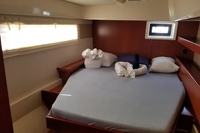 Zumbrota Yacht Photos Pics Cozy cabin bedroom in 2014 Leopard 48 yacht with striped bedding and decorative towels.