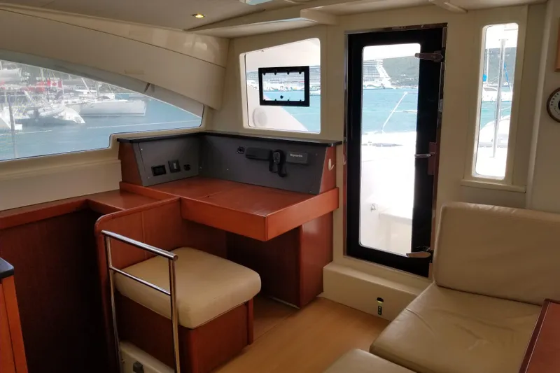 Zumbrota Yacht Photos Pics Interior of 2014 Leopard 48 yacht with desk, seating, and ocean view.
