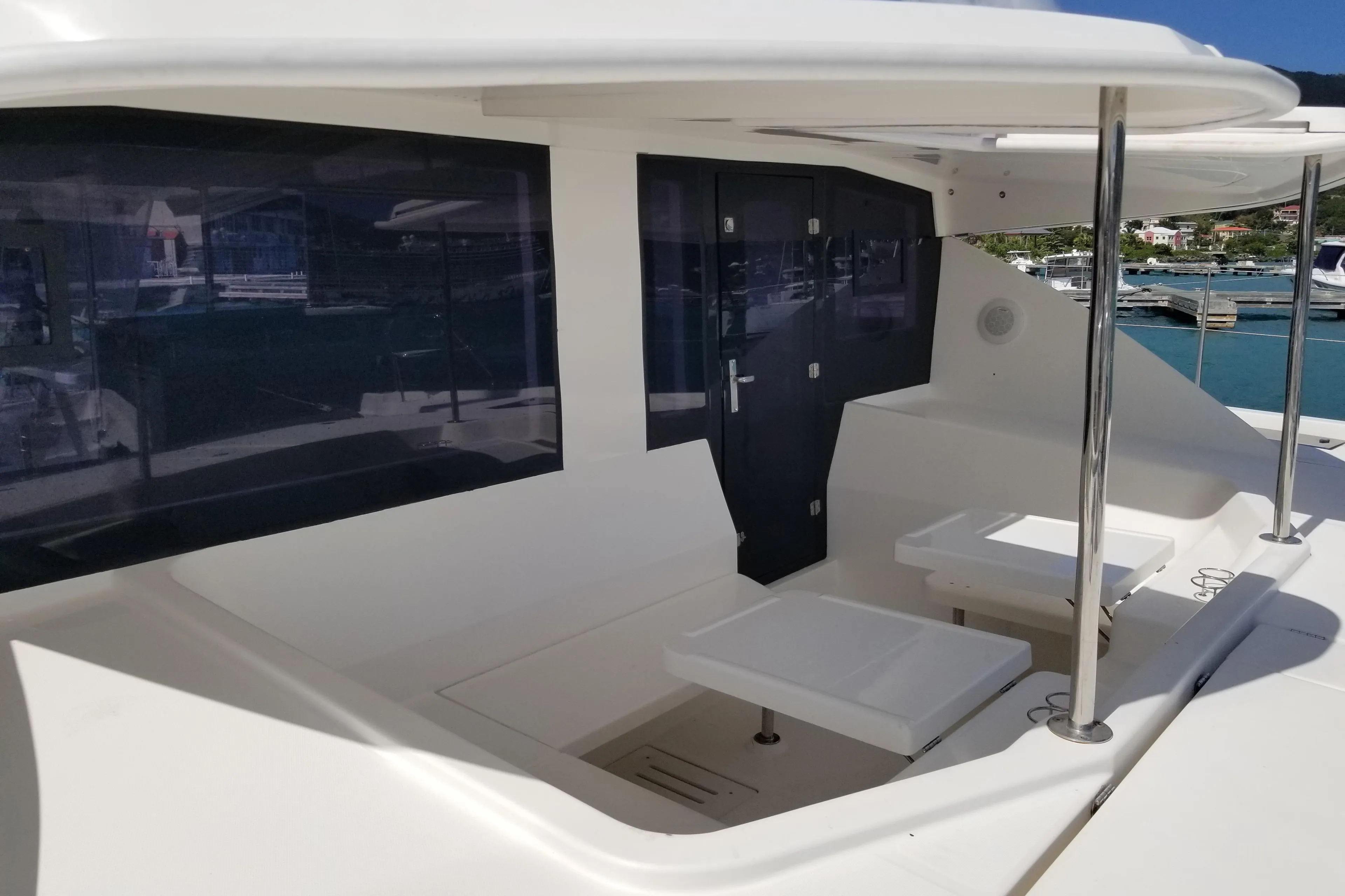 Luxurious 2014 Leopard 48 yacht deck with seating area, docked at marina.
