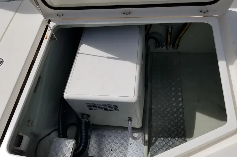 Zumbrota Yacht Photos Pics Storage compartment in a 2014 Leopard 48 yacht, featuring a secured white unit.