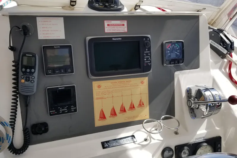 Zumbrota Yacht Photos Pics Control panel of a 2014 Leopard 48 yacht with navigation instruments and throttle controls.