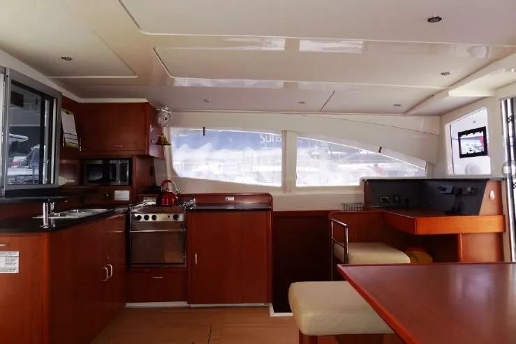 Zumbrota Yacht Photos Pics Luxurious interior of a 2014 Leopard 48 yacht with modern kitchen and seating area.
