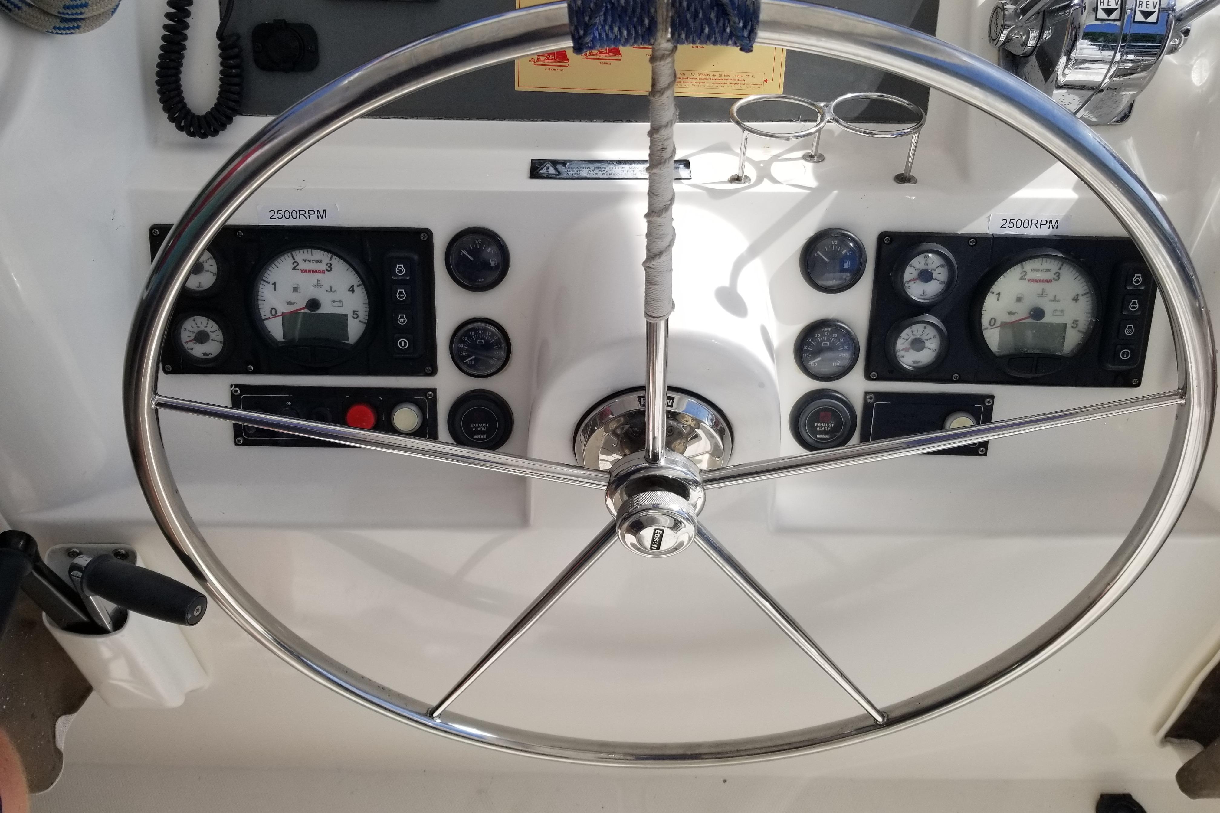 Steering wheel and dashboard of 2014 Leopard 48 yacht, showing gauges and controls.