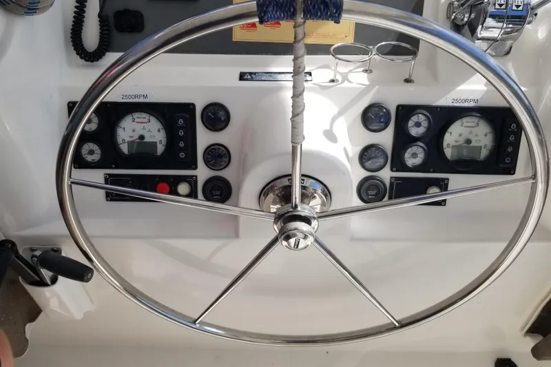 Zumbrota Yacht Photos Pics Steering wheel and dashboard of 2014 Leopard 48 yacht, showing gauges and controls.