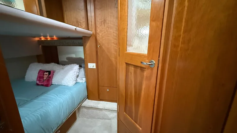 Dazilus Yacht Photos Pics Cozy cabin interior of 2001 Silverton 410 Sport Bridge with wooden finishes and bedding.