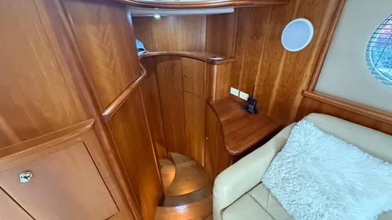 Dazilus Yacht Photos Pics Interior of 2001 Silverton 410 Sport Bridge with wooden staircase and cozy seating area.