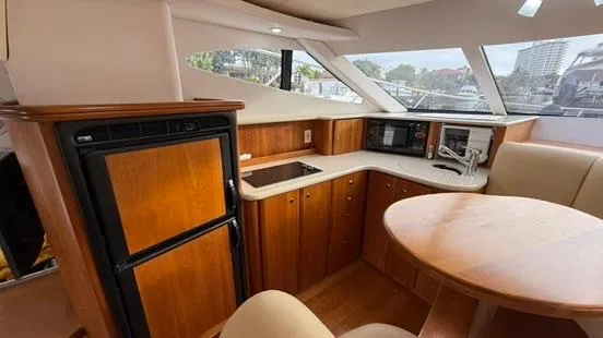 Dazilus Yacht Photos Pics Interior of 2001 Silverton 410 Sport Bridge yacht with wood cabinetry and modern appliances.