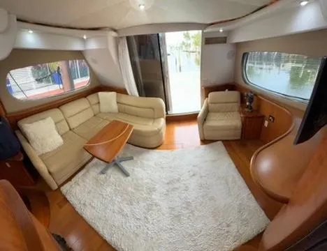Dazilus Yacht Photos Pics Interior of 2001 Silverton 410 Sport Bridge yacht with beige seating and wooden accents.