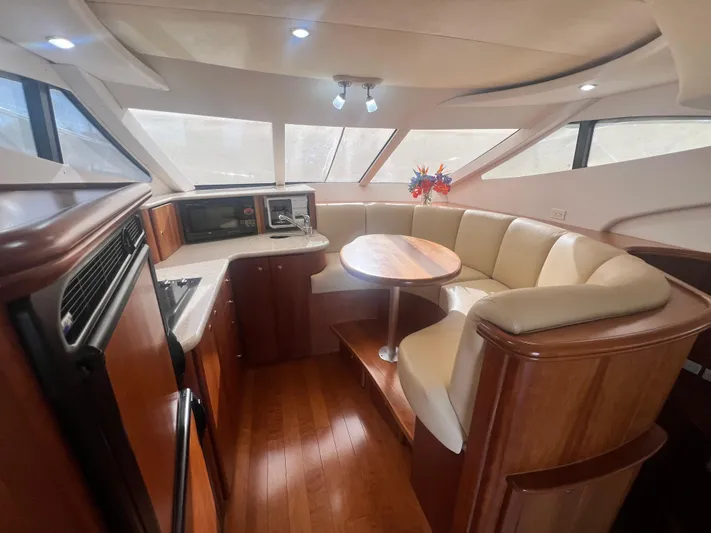 Dazilus Yacht Photos Pics Interior of 2001 Silverton 410 Sport Bridge yacht with elegant seating and wood finishes.