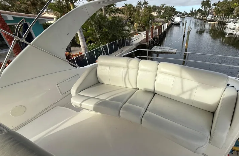 Dazilus Yacht Photos Pics 2001 Silverton 410 Sport Bridge with white seating, docked near a canal.