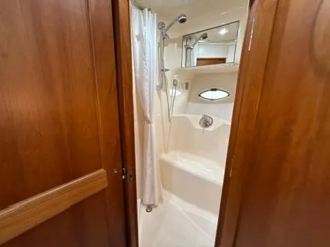 Dazilus Yacht Photos Pics Bathroom interior of 2001 Silverton 410 Sport Bridge yacht with shower and wooden accents.