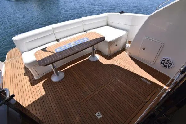 No Contingencies Yacht Photos Pics 2012 Riviera 440 Sport Yacht deck with white seating and wooden table.