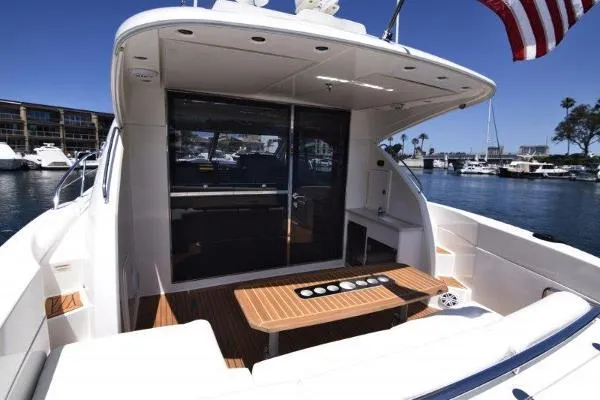 No Contingencies Yacht Photos Pics 2012 Riviera 440 Sport Yacht with spacious deck, docked in a sunny marina.