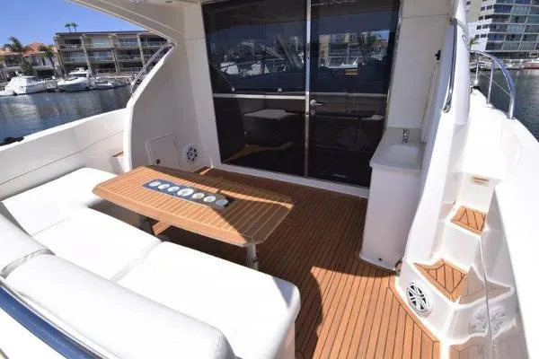 No Contingencies Yacht Photos Pics 2012 Riviera 440 Sport Yacht with teak deck and white seating in marina.