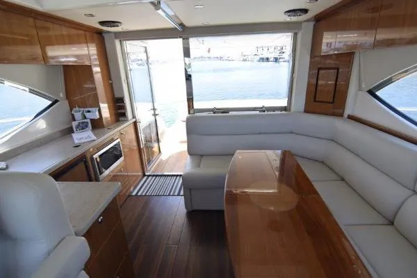 No Contingencies Yacht Photos Pics Luxurious interior of 2012 Riviera 440 Sport Yacht with elegant seating and wood finishes.