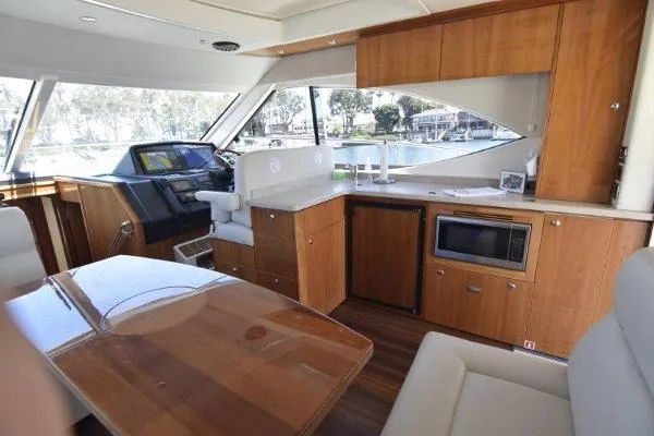 No Contingencies Yacht Photos Pics Interior of 2012 Riviera 440 Sport Yacht with modern kitchen and helm station.