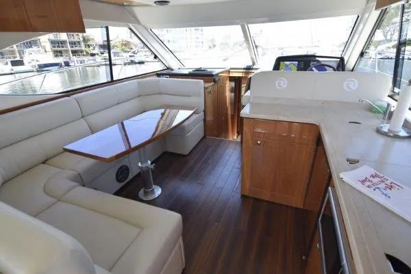 No Contingencies Yacht Photos Pics Luxurious interior of 2012 Riviera 440 Sport Yacht with elegant seating and wooden finishes.