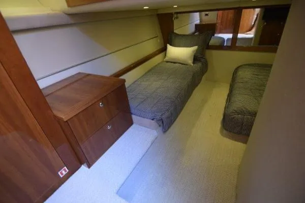 No Contingencies Yacht Photos Pics 2012 Riviera 440 Sport Yacht cabin with twin beds and wooden cabinetry.