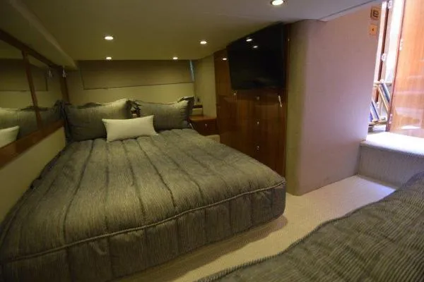 No Contingencies Yacht Photos Pics Luxurious bedroom interior of 2012 Riviera 440 Sport Yacht with cozy bedding and modern decor.