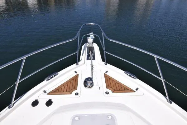 No Contingencies Yacht Photos Pics Bow view of 2012 Riviera 440 Sport Yacht on calm water.