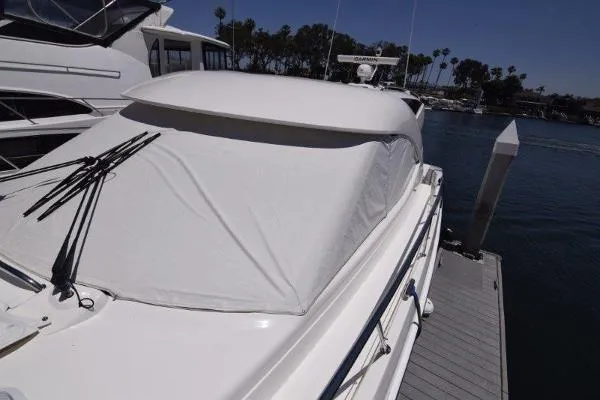 No Contingencies Yacht Photos Pics 2012 Riviera 440 Sport Yacht docked, covered, with clear skies and waterfront view.
