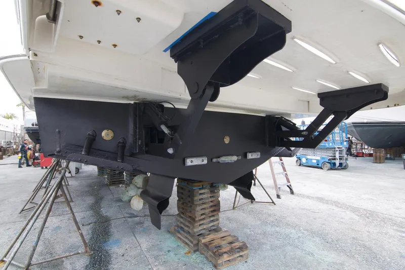 No Contingencies Yacht Photos Pics 2012 Riviera 440 Sport Yacht under maintenance, showing hull and propeller area in a boatyard.